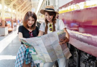 Happy Travel Together Of Two Young Woman Looking Map In Train St
