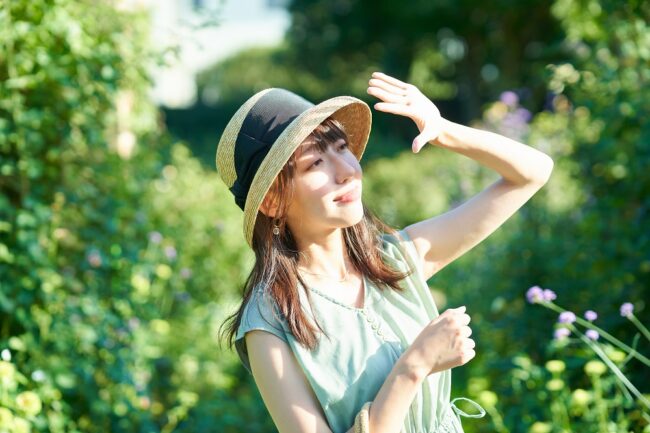 A woman blocking the strong sunlight with her hand