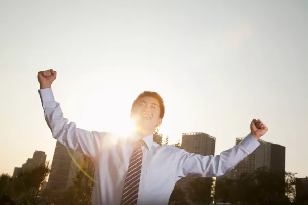 Young Businessman With Fists In The Air Celebrating